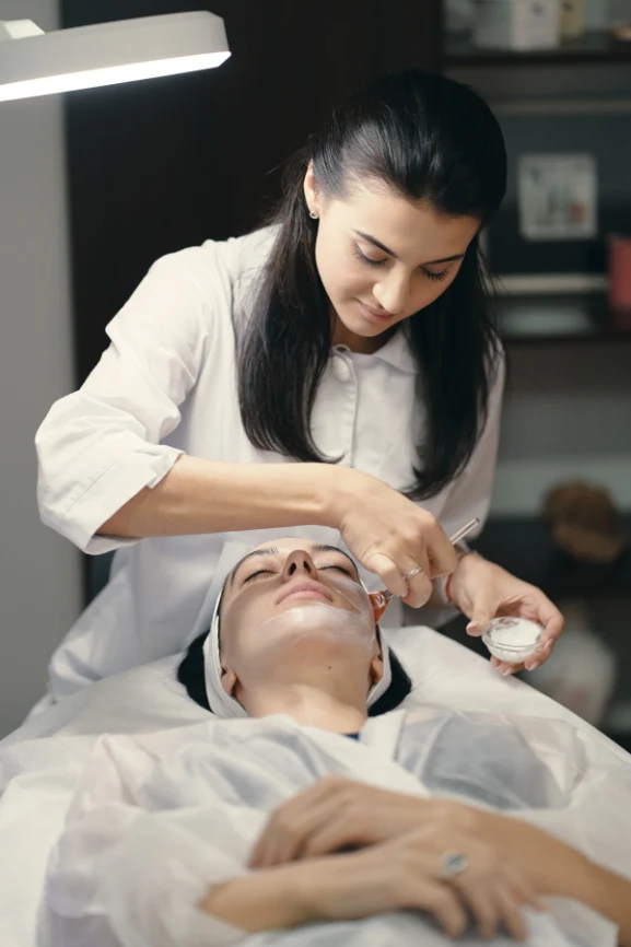 Certified skin specialist performing facial treatment at Skin Creations aesthetic clinic Singapore